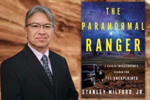 Author Stanley Milford, Jr. shown next to his book The Paranormal Ranger against a desert background