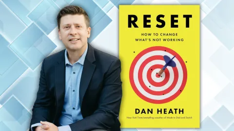 Man in a suit jacket next to a picture of a yellow book with a bullseye on the cover.