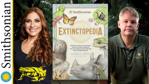 Red haired woman and grey haired man on either side of their book against a jungle background.