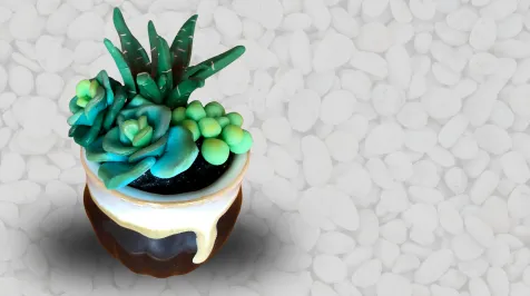 A miniature succulent garden and pot made out of polymer clay.
