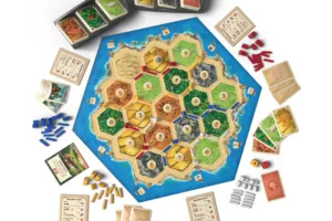 Pieces of a board game with tiles, cards, and wooden shapes.