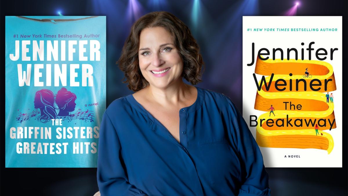 Woman in blue shirt in from of two books, one blue and one white with orange and yellow bands.