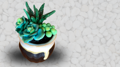 A miniature succulent garden and pot made out of polymer clay.